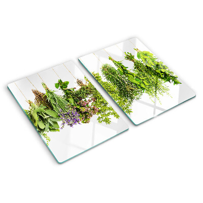 Tagliere in vetro con stampa di erbe appese su spago