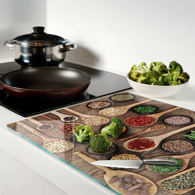 Tagliere in vetro temperato con motivo di spezie ed erbe rappresentate su cucchiai