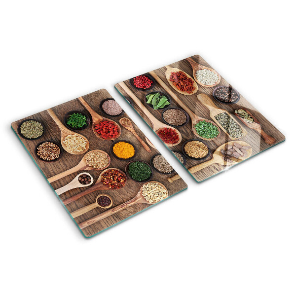 Tagliere in vetro temperato con motivo di spezie ed erbe rappresentate su cucchiai