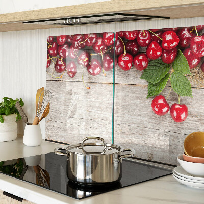 Tagliere in vetro con stampa di ciliegie su sfondo di legno