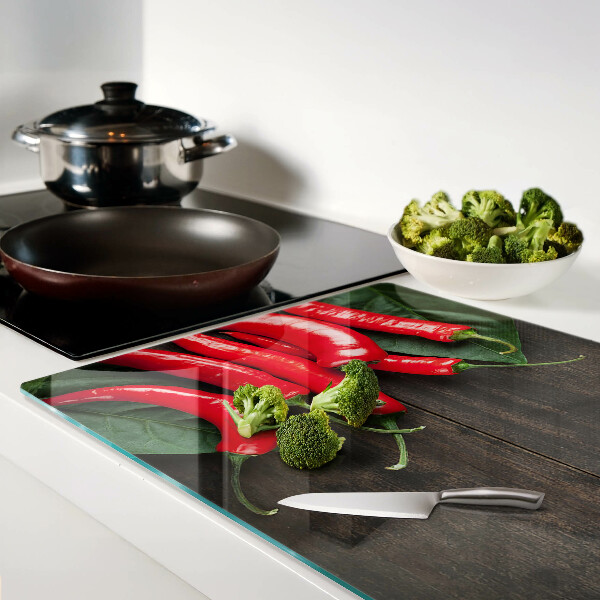 Tagliere in vetro temperato con stampa di peperoncini su sfondo di legno