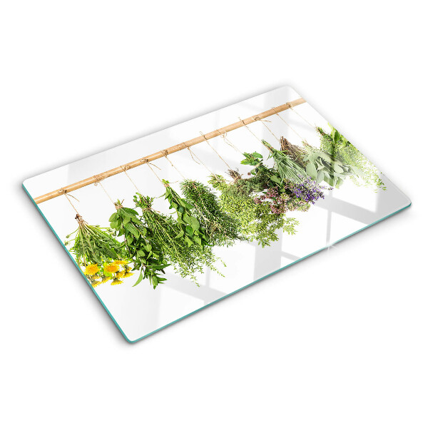 Tagliere in vetro temperato con stampa di erbe essiccate su sfondo a spago