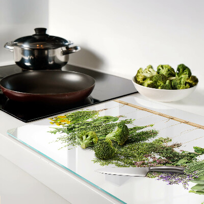 Tagliere in vetro temperato con stampa di erbe essiccate su sfondo a spago