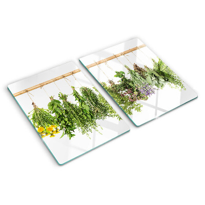 Tagliere in vetro temperato con stampa di erbe essiccate su sfondo a spago