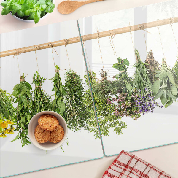 Tagliere in vetro temperato con stampa di erbe essiccate su sfondo a spago