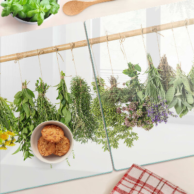 Tagliere in vetro temperato con stampa di erbe essiccate su sfondo a spago