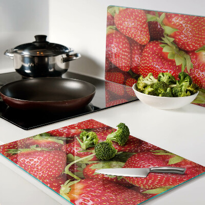 Tagliere in vetro temperato con motivo di fragole sullo sfondo