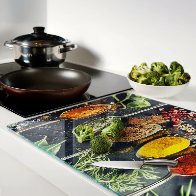 Tagliere in vetro con motivo di spezie nei cucchiai