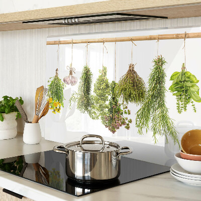 Tagliere in vetro temperato con decorazione di erbe disposte a mazzetti appesi