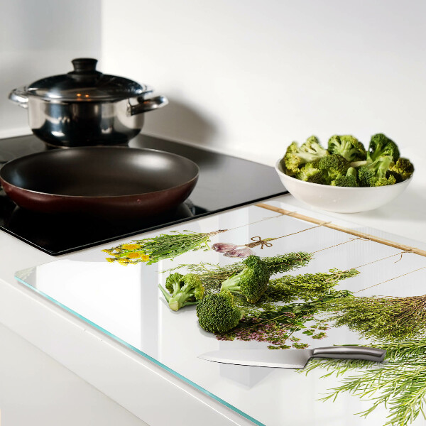 Tagliere in vetro temperato con decorazione di erbe disposte a mazzetti appesi
