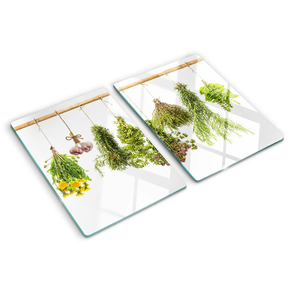 Tagliere in vetro temperato con decorazione di erbe disposte a mazzetti appesi