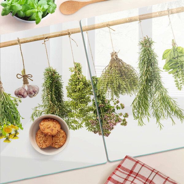 Tagliere in vetro temperato con decorazione di erbe disposte a mazzetti appesi
