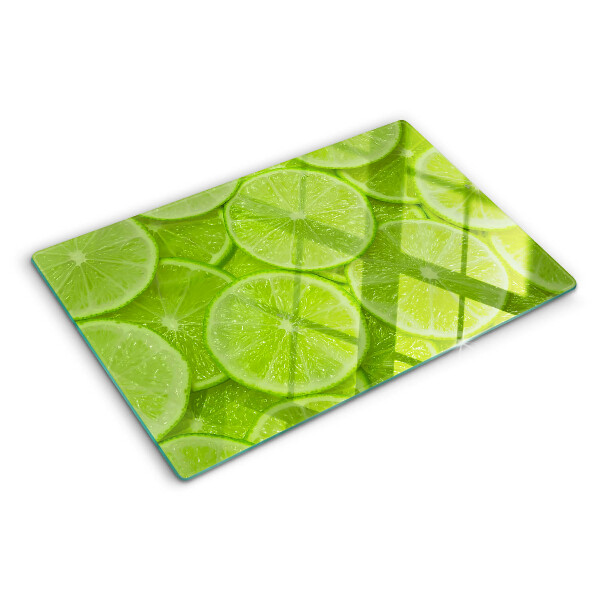 Tagliere in vetro temperato Fette di lime su sfondo verde