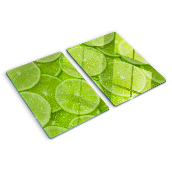 Tagliere in vetro temperato Fette di lime su sfondo verde