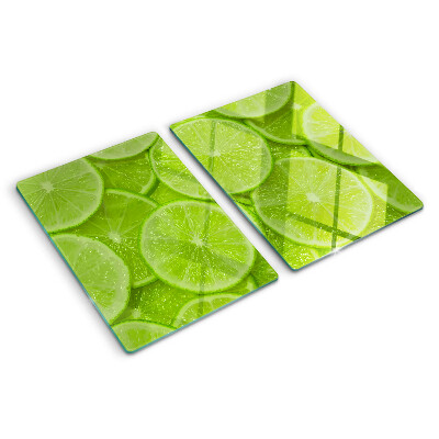 Tagliere in vetro temperato Fette di lime su sfondo verde