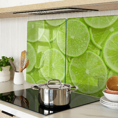 Tagliere in vetro temperato Fette di lime su sfondo verde