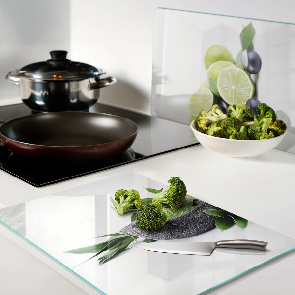 Tagliere in vetro con motivo di limoni e uva su sfondo verde