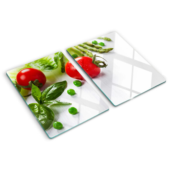 Tagliere in vetro temperato con stampa di verdure su sfondo di piano bianco