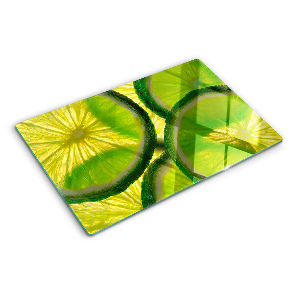 Tagliere in vetro temperato Fette di lime su sfondo verde