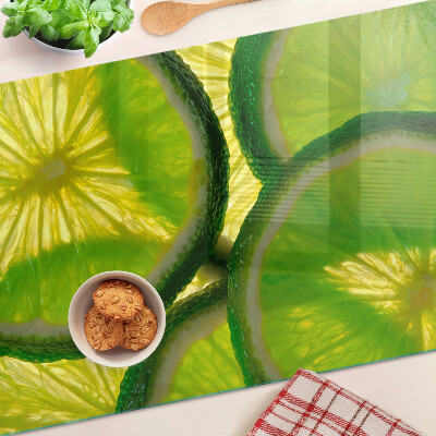 Tagliere in vetro temperato Fette di lime su sfondo verde