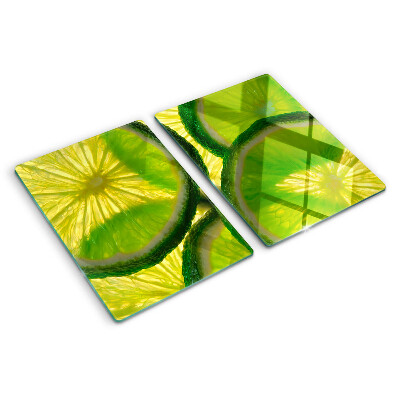 Tagliere in vetro temperato Fette di lime su sfondo verde