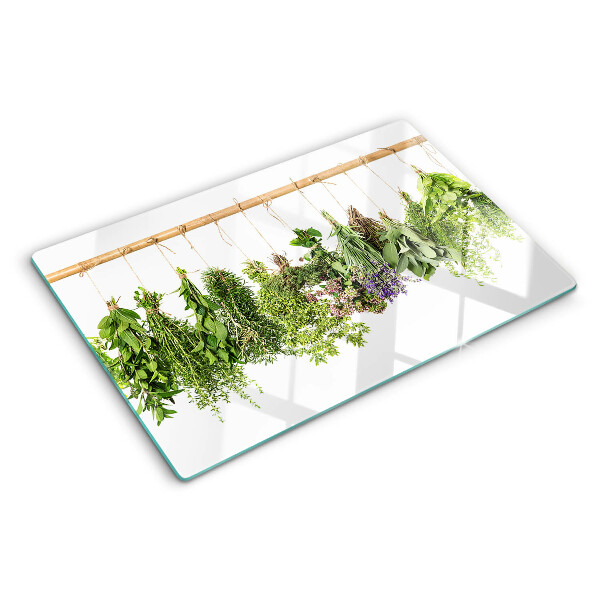 Tagliere in vetro temperato con stampa di erbe essiccate su sfondo a spago