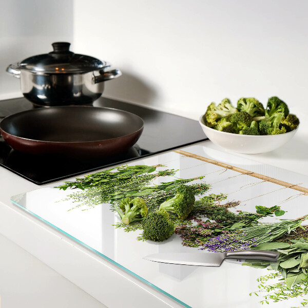 Tagliere in vetro temperato con stampa di erbe essiccate su sfondo a spago