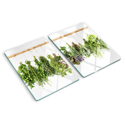 Tagliere in vetro temperato con stampa di erbe essiccate su sfondo a spago