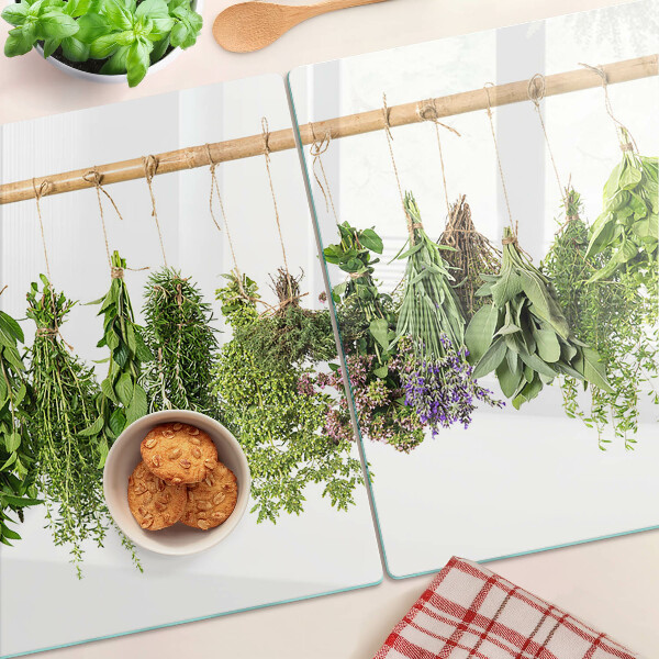 Tagliere in vetro temperato con stampa di erbe essiccate su sfondo a spago