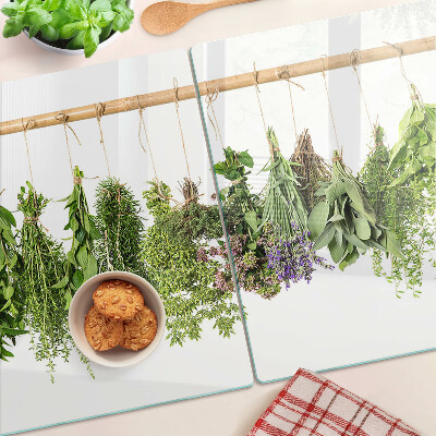 Tagliere in vetro temperato con stampa di erbe essiccate su sfondo a spago