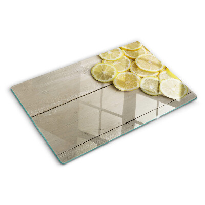 Tagliere in vetro temperato Fette di limone su sfondo di legno