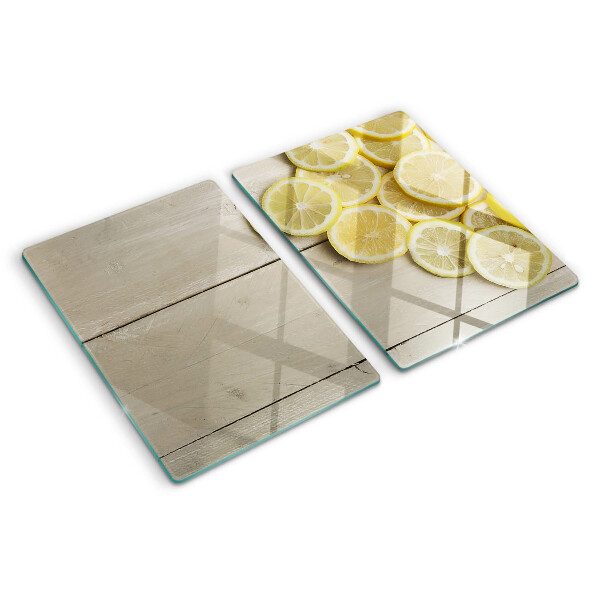 Tagliere in vetro temperato Fette di limone su sfondo di legno