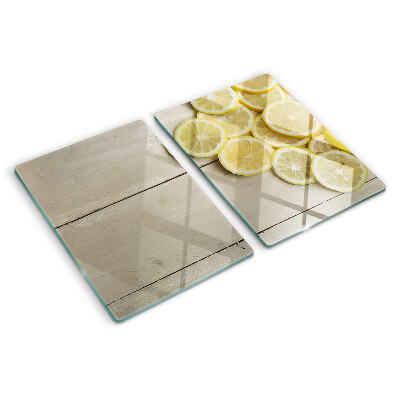 Tagliere in vetro temperato Fette di limone su sfondo di legno