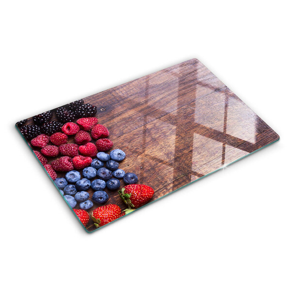 Tagliere in vetro temperato con stampa di frutti di bosco su sfondo di legno