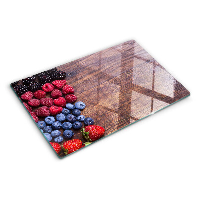 Tagliere in vetro temperato con stampa di frutti di bosco su sfondo di legno