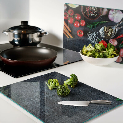 Tagliere in vetro temperato con stampa di verdure e spezie su sfondo scuro
