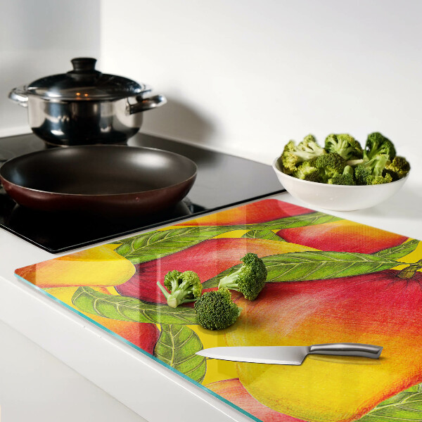 Tagliere in vetro temperato con motivo di peperoni su sfondo di foglie verdi