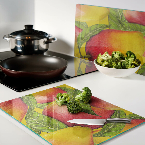 Tagliere in vetro temperato con motivo di peperoni su sfondo di foglie verdi