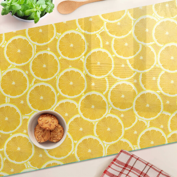 Tagliere in vetro temperato Fette di limone su sfondo giallo