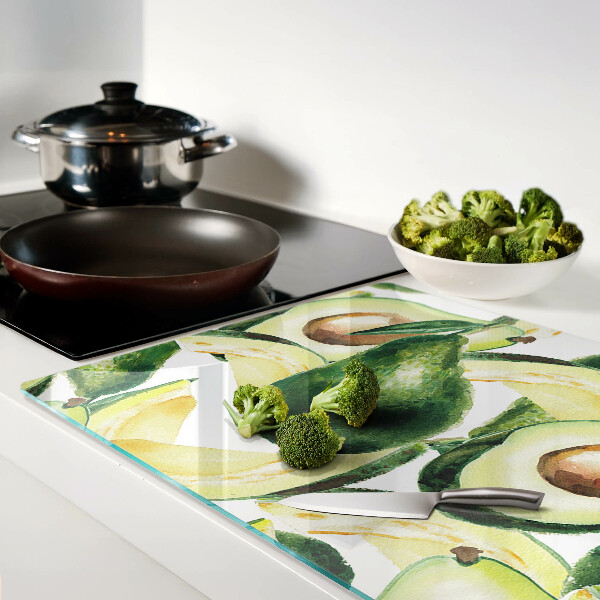 Tagliere in vetro temperato Avocado sullo sfondo di foglie