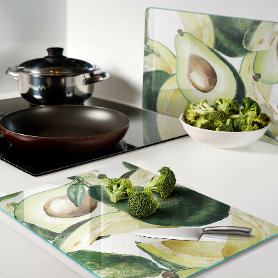 Tagliere in vetro temperato Avocado sullo sfondo di foglie