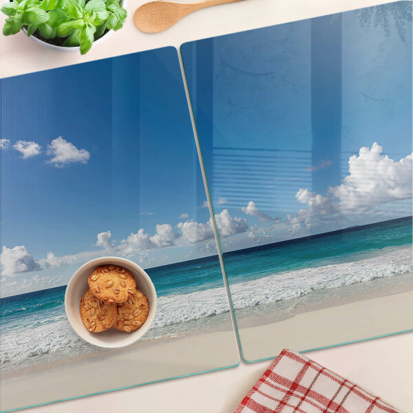Tagliere in vetro temperato con stampa della spiaggia con acqua turchese e nuvole