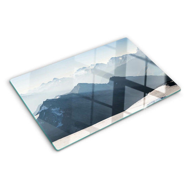 Tagliere in vetro con stampa di un paesaggio montano tra le nuvole