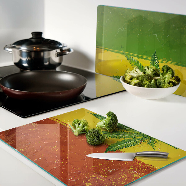 Tagliere in vetro temperato con stampa di foglia di canapa su sfondo colorato