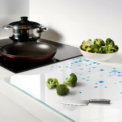 Tagliere in vetro con motivo di quadrati blu su sfondo bianco