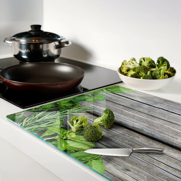 Tagliere in vetro temperato con motivo di erbe verdi su sfondo in legno