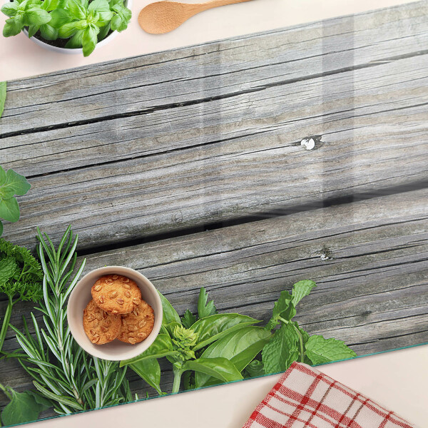 Tagliere in vetro temperato con motivo di erbe verdi su sfondo in legno