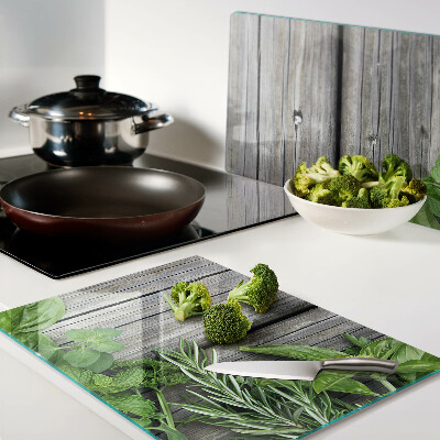 Tagliere in vetro temperato con motivo di erbe verdi su sfondo in legno