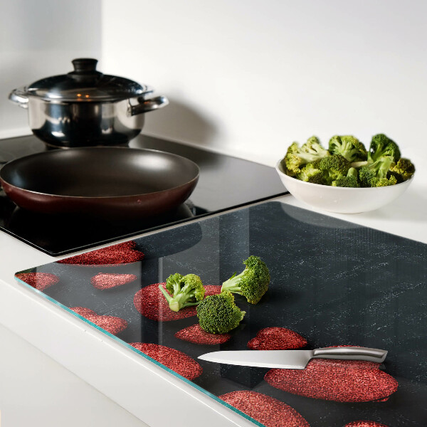 Tagliere in vetro temperato con motivo a cuori rossi su sfondo scuro