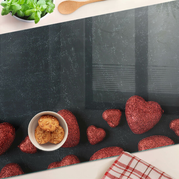 Tagliere in vetro temperato con motivo a cuori rossi su sfondo scuro